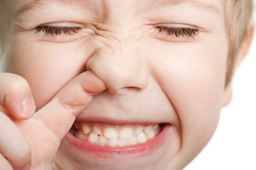 Close-eyed kid picking nose with his mouth open