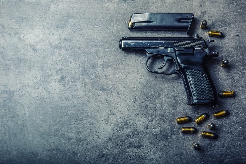 9mm pistol gun and bullets strewn on the table
