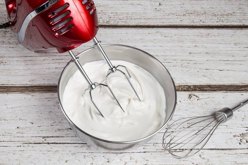 Electric hand mixer with whipped cream and whisk