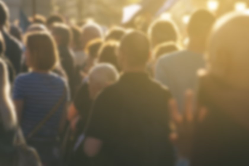 Defocused crowd attending political meeting, large group of people