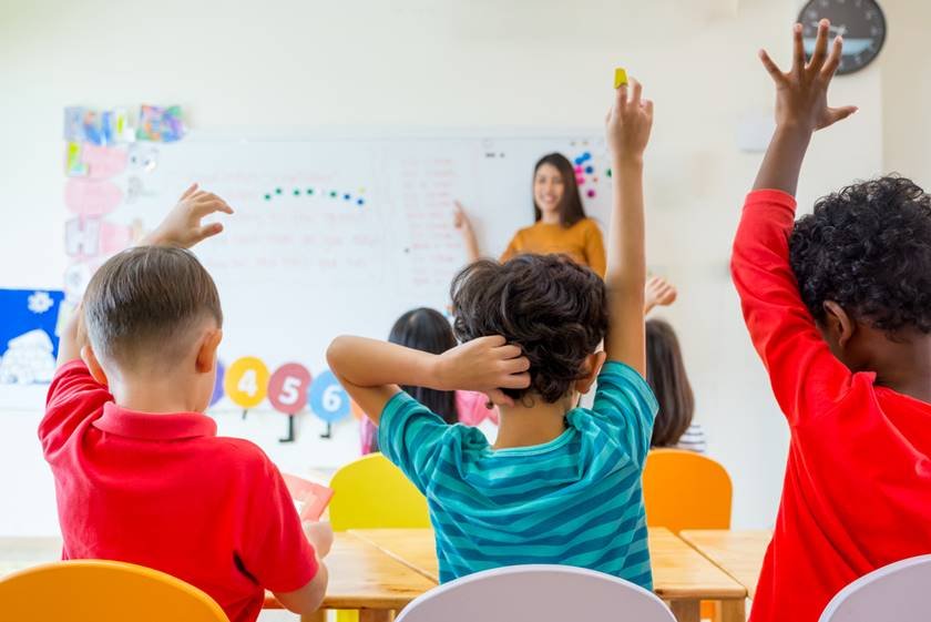 professor Preschool kid raise arm up to answer teacher question on whiteboard in classroom,Kindergarten education concept
