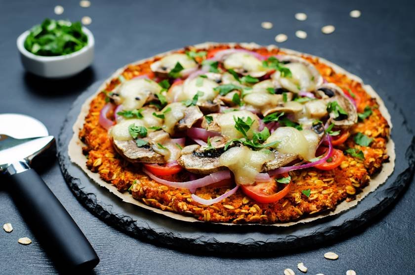 Sweet potato pizza crust with tomato, red onion and mushrooms