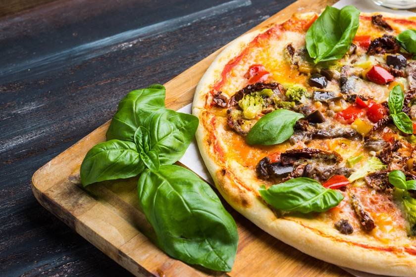 Fresh pizza on wooden table