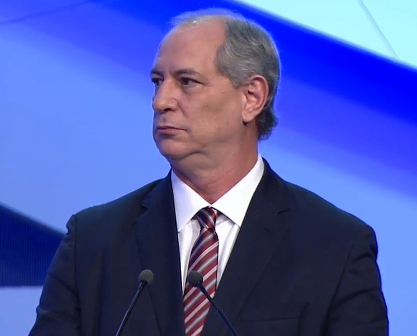 Ciro Gomes em debate da TV Bandeirantes. Ele olha para o lado, sob fundo azul - Metrópoles