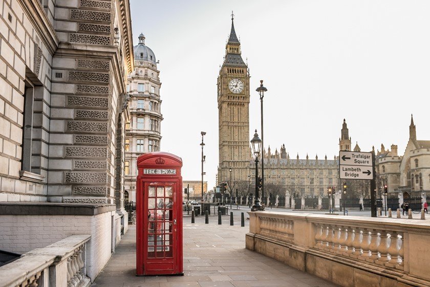 London - Big Ben tower and a red telephone booth