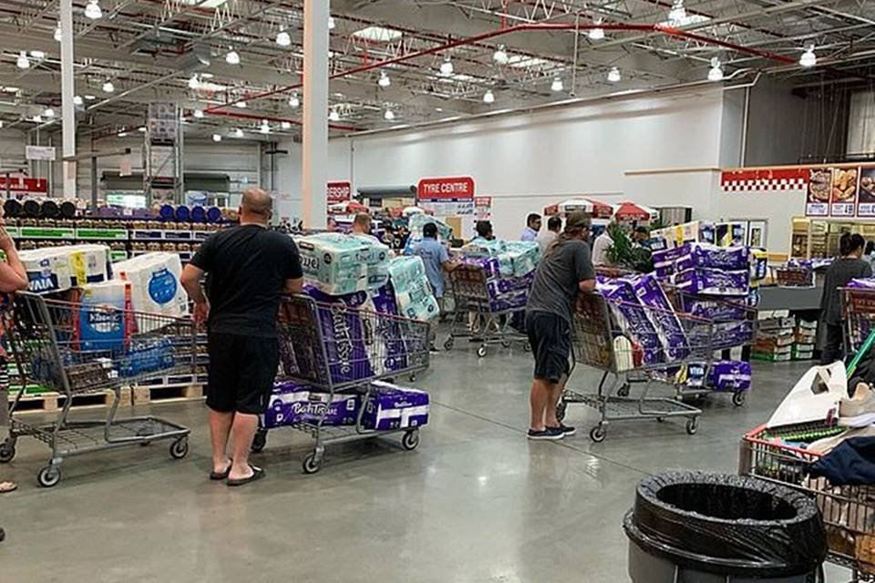 Pessoas com carrinhos de compra em supermercado