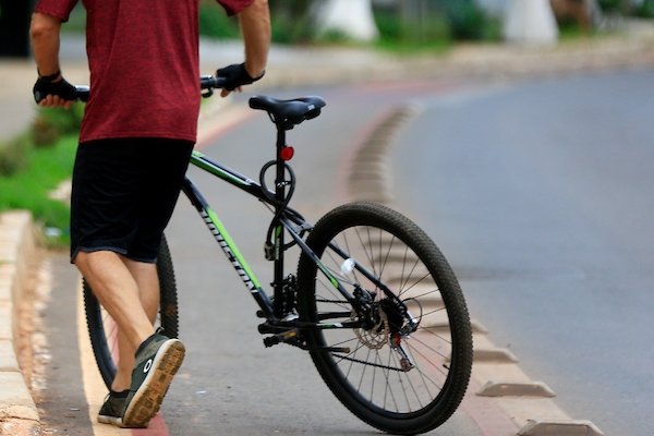Homem com bicicleta em ciclovia de Águas Claras