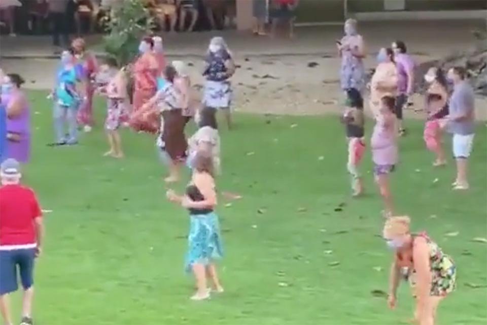 Idosos dançam em gramado de hotel