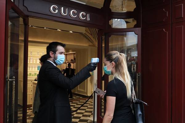 Temperatura sendo medida em porta de loja da Gucci