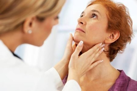 Imagem de médica examinando pescoço de mulher idosa - Metrópoles