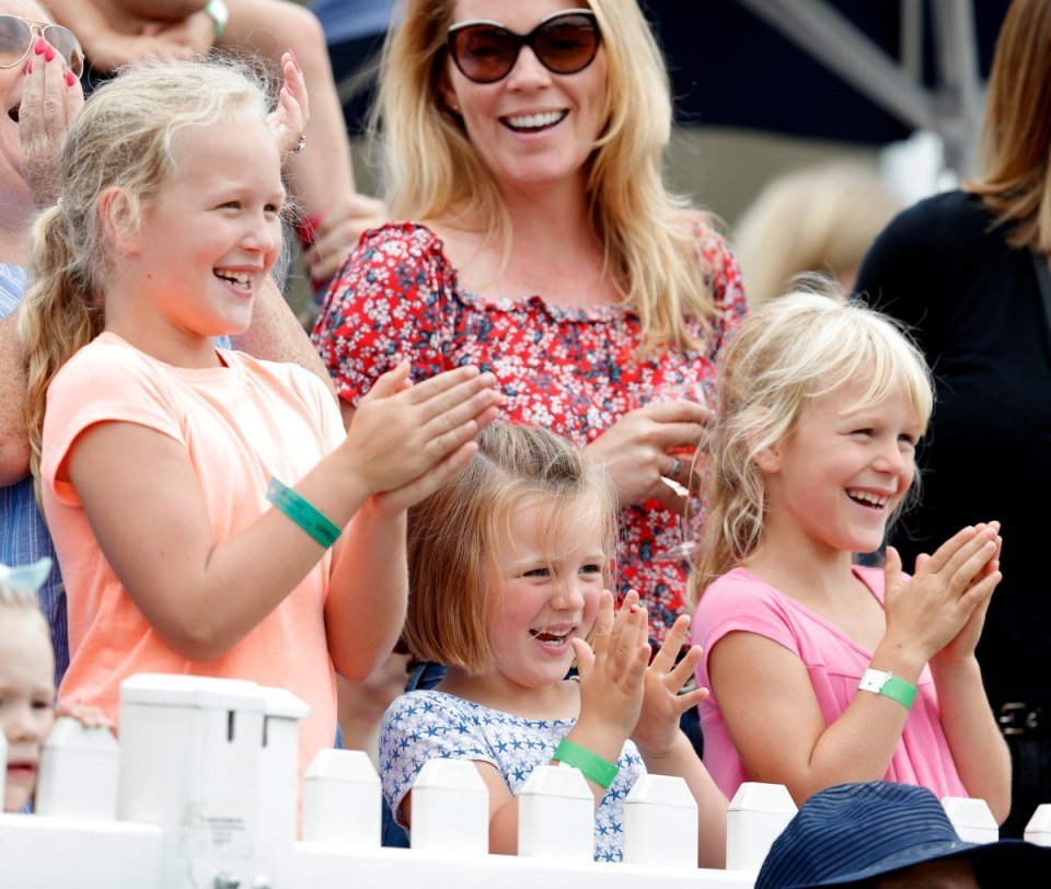 STROUD, UNITED KINGDOM - AUGUST 03: (EMBARGOED FOR PUBLICATION IN UK NEWSPAPERS UNTIL 24 HOURS AFTER CREATE DATE AND TIME) Savannah Phillips, Mia Tindall and Isla Phillips cheer as they watch the Shetland Pony Grand National on day 2 of the 2019 Festival of British Eventing at Gatcombe Park on August 3, 2019 in Stroud, England. (Photo by Max Mumby/Indigo/Getty Images)
