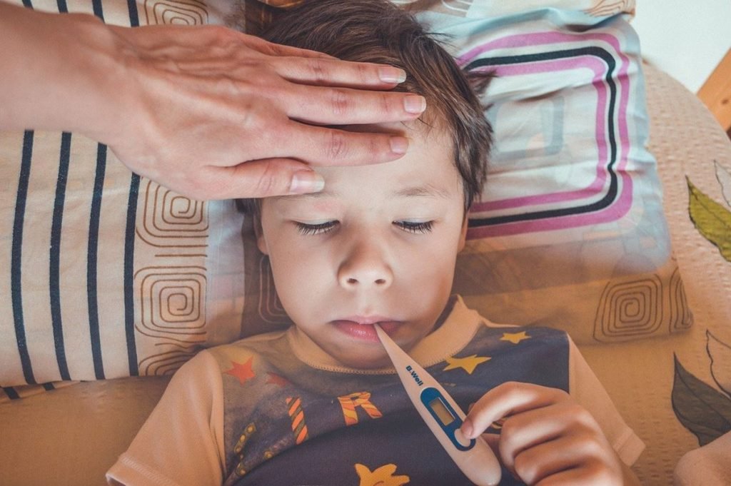 Color photograph of a child sick with fever