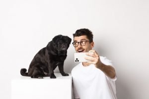Dono de cachorro tirando selfie com pet