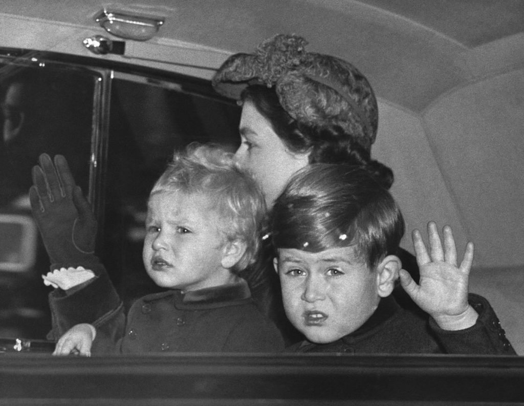 Prince Charles in the back of the car with his mother Queen Elizabeth and sister Princess Anne in 1953