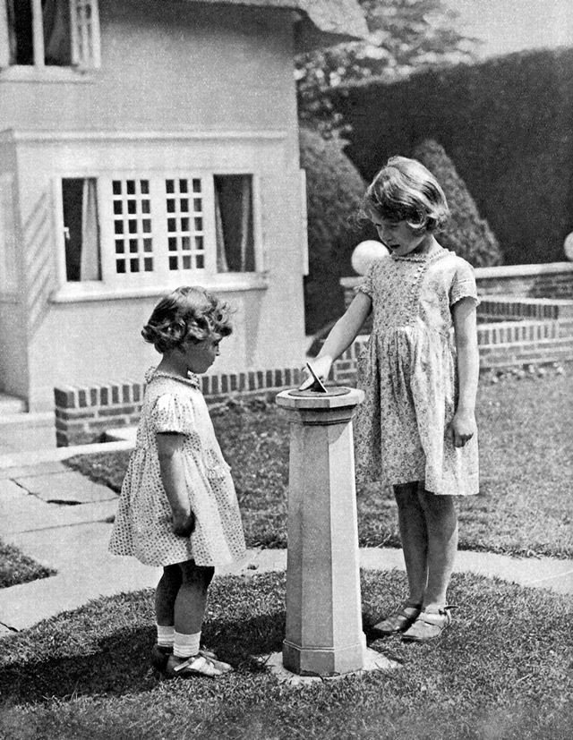 Princess Elizabeth (to become Queen Elizabeth II) and Princess Margaret as children in the 'grounds' of the model house
