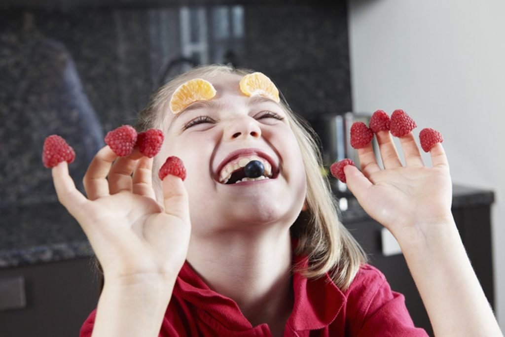 Criança comendo fruta