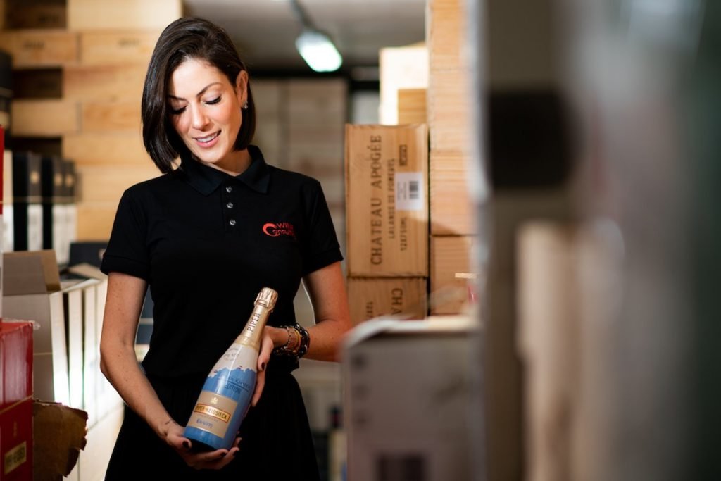 mulher segurando garrafa de champagne
