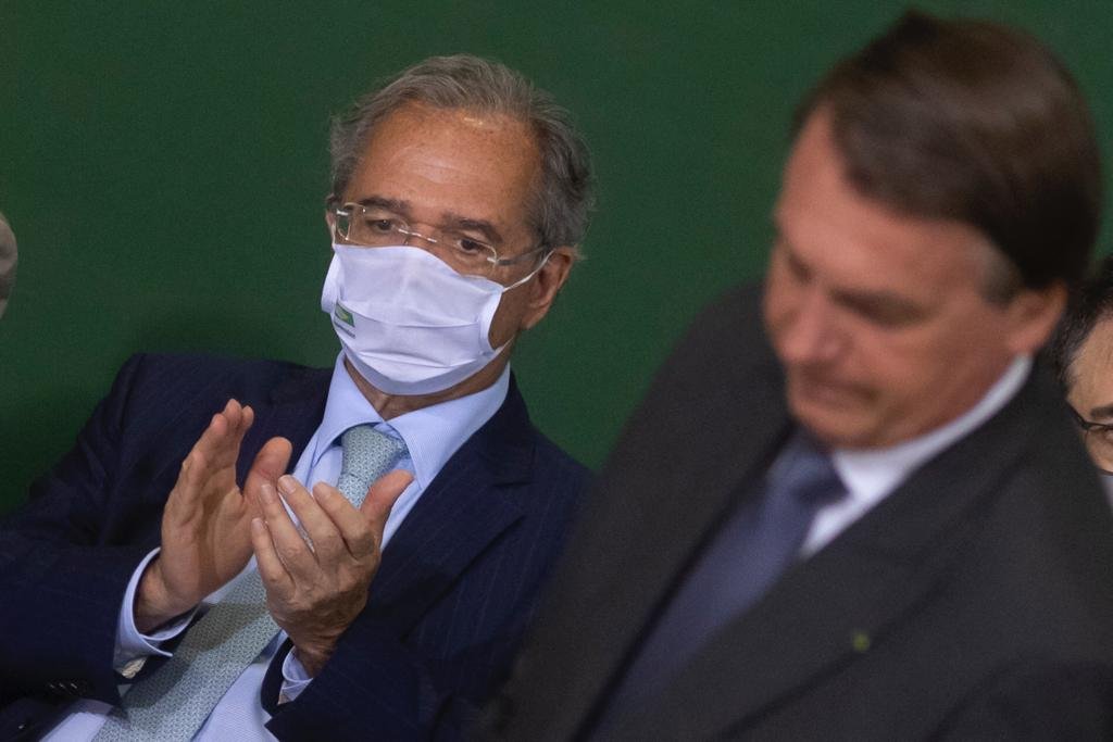 Ministro da economia Paulo Guedes, e Bolsonaro durante assinatura do programa