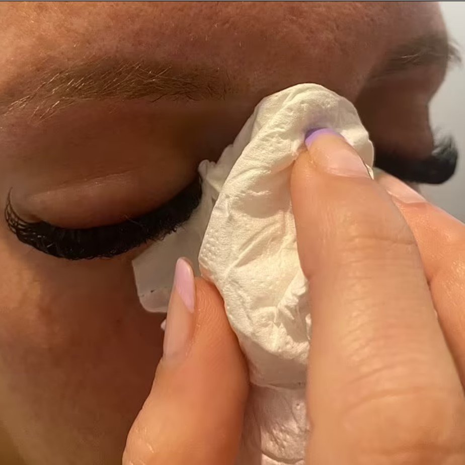 Mulher limpa os olhos com lenço de papel