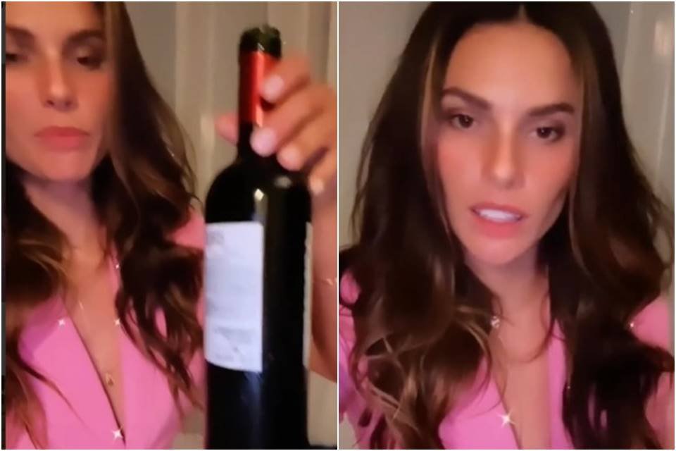 Dayane Mello segurando garrafa de vinho