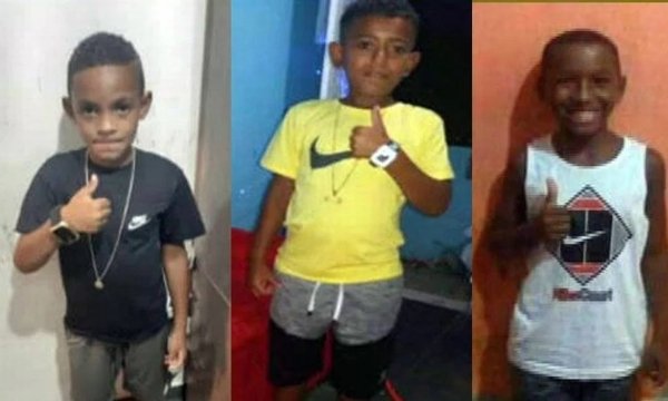 Na fotografia colorida, as três crianças desaparecidas posam para fotos com sinal de 