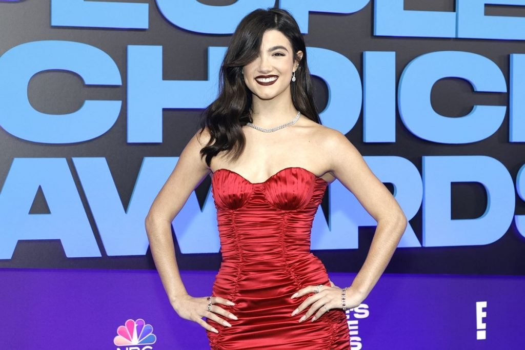 Jovem de cabelos pretos veste vestido vermelho