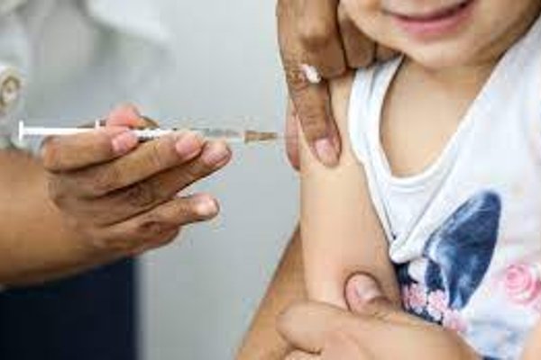 Color photograph of a child receiving a vaccine