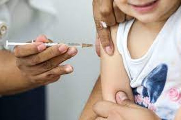 Colored photograph of a child getting a vaccine