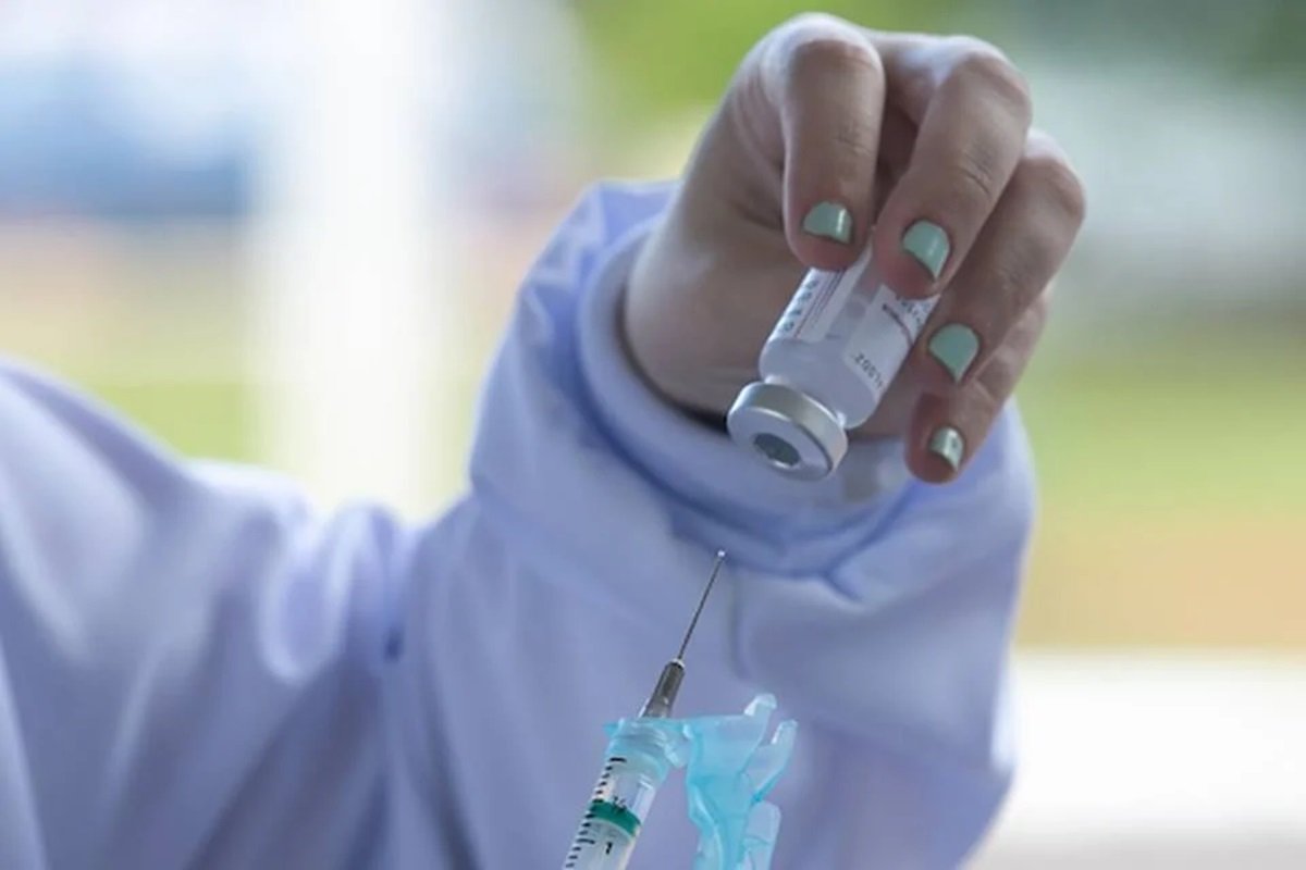 enfermeira segura seringa com vacina