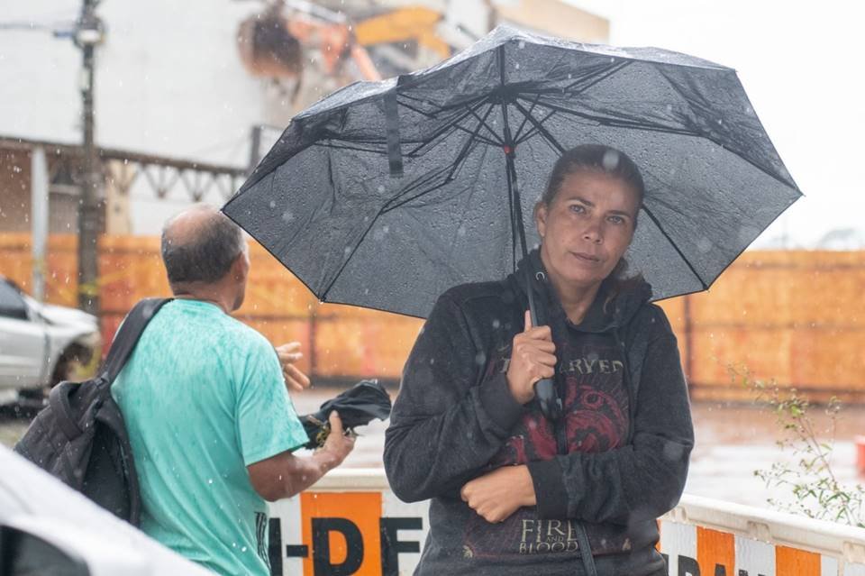 Mulher com roupa preta e guarda-chuva preto