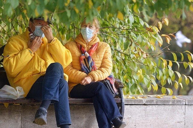 Color photograph of elderly people sitting in the street