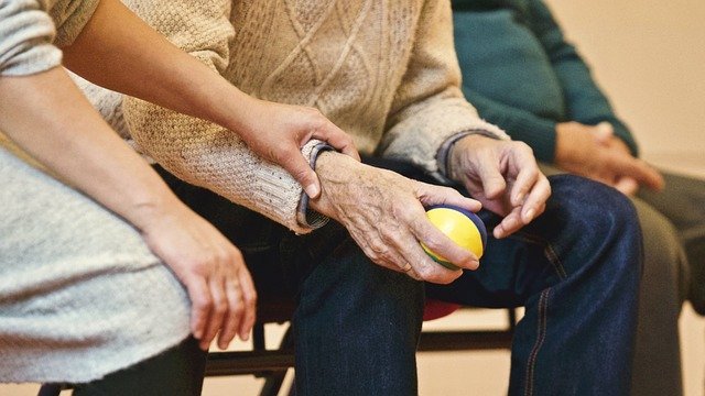 Photo of elderly man holding ball