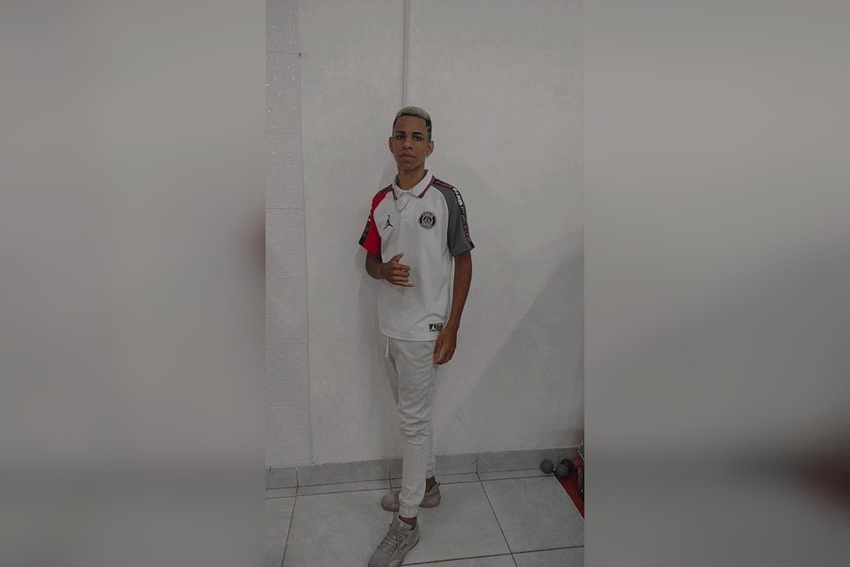 jovem tira foto em frente a parede branca