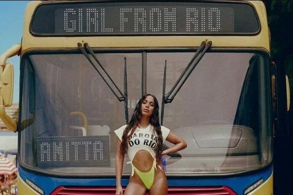Singer Anitta poses for a photo.  She is wearing a bathing suit and looking seriously into the camera on the camera - Metropolis