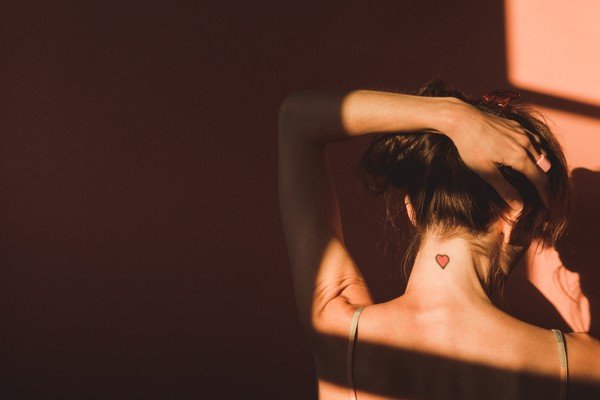 Woman moving her hair while admiring her shadow on the wall - Metropolis