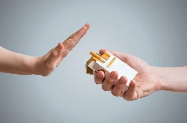 Cigarette offering hand and the other hand rejecting - Mahanagar