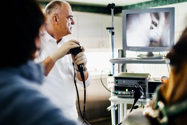 The doctor performs an endoscopy on the patient and observes the images on the camera