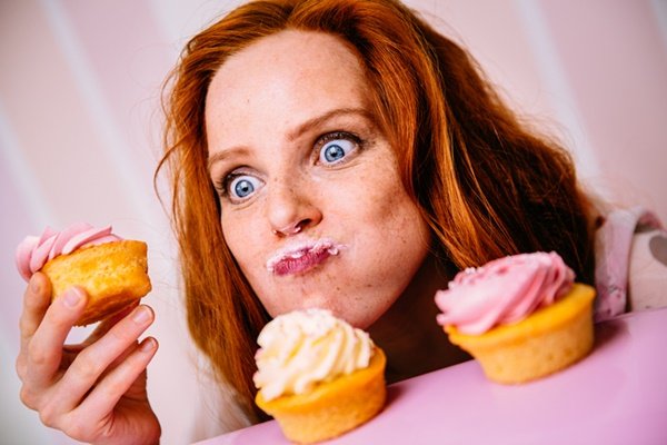 Redhead woman eating sweets - Metropolis