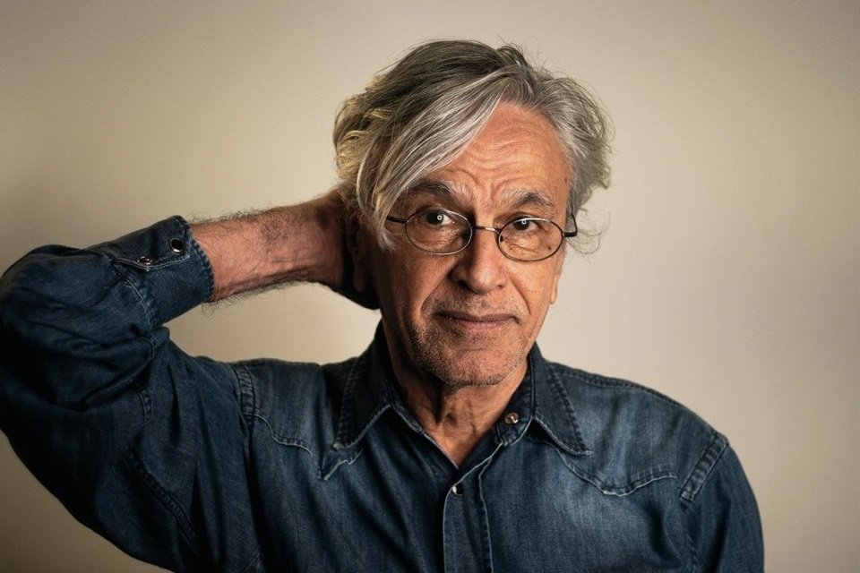 Foto colorida de Caetano Veloso. Ele está de jaqueta jeans, usa óculos de grau e tem cabelos grisalhos - Metrópoles