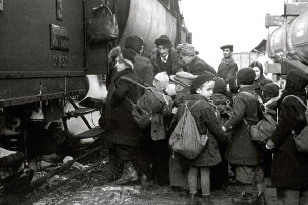 Na imagem em preto e branco as crianças aparecem embarcando em trem-Metrópoles