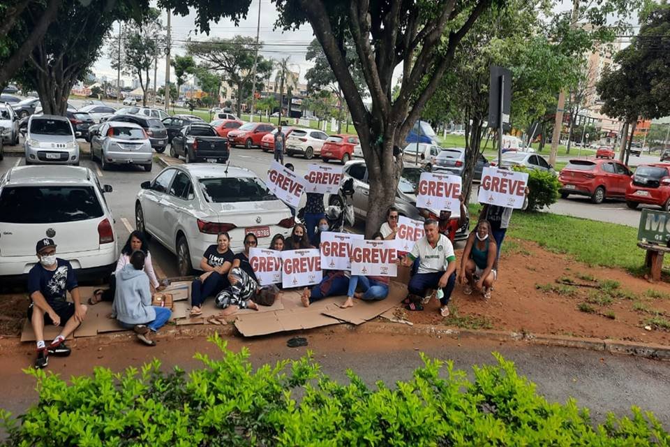 Pessoas sentadas em calçada