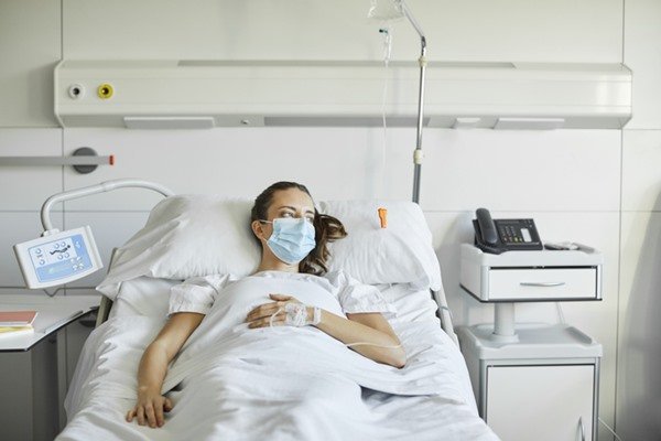 Woman lying on a hospital stretcher - Metropolis