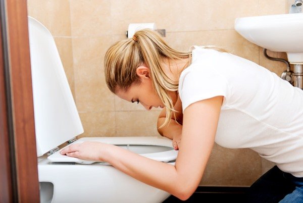 Woman in front of toilet looks like she's about to vomit - Metropolis