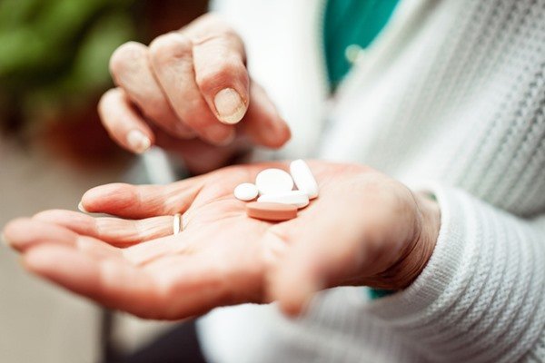 Person holding pills in hands - Metropolises