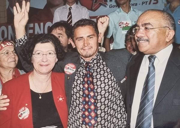 Fotografia colorida de grupo de pessoas se abraçando