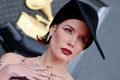 Halsey com vestido preto em duas partes e chapeu no tapete vermelho do Grammy 2022 - Metrópoles