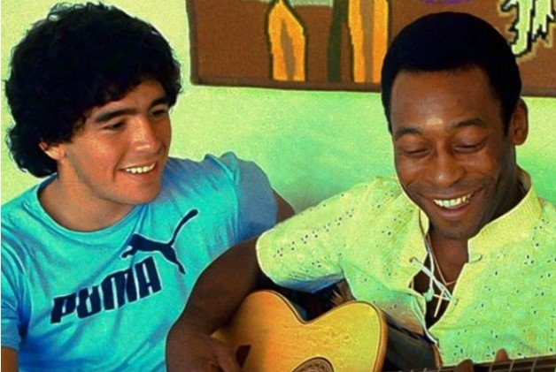 Maradona and Pele, side by side.  Pelé holds a guitar - Metropolises