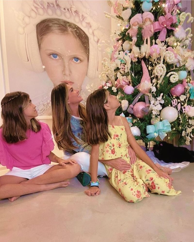 A atriz Giovanna Antonelli e suas filhas gêmeas sentadas na árvore de Natal