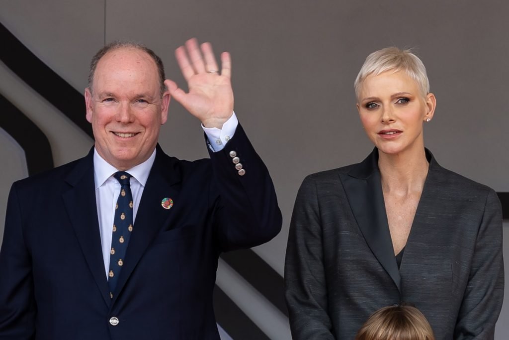 Príncipe Albert e princesa Charlene de Mônaco em evento. Ele acena para frente - Metrópoles
