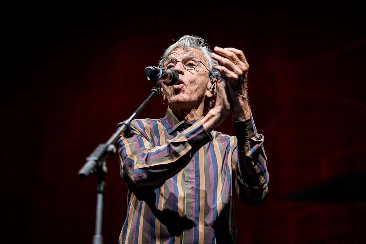Foto colorida de Caetano Veloso cantando e batendo palma - Metrópoles